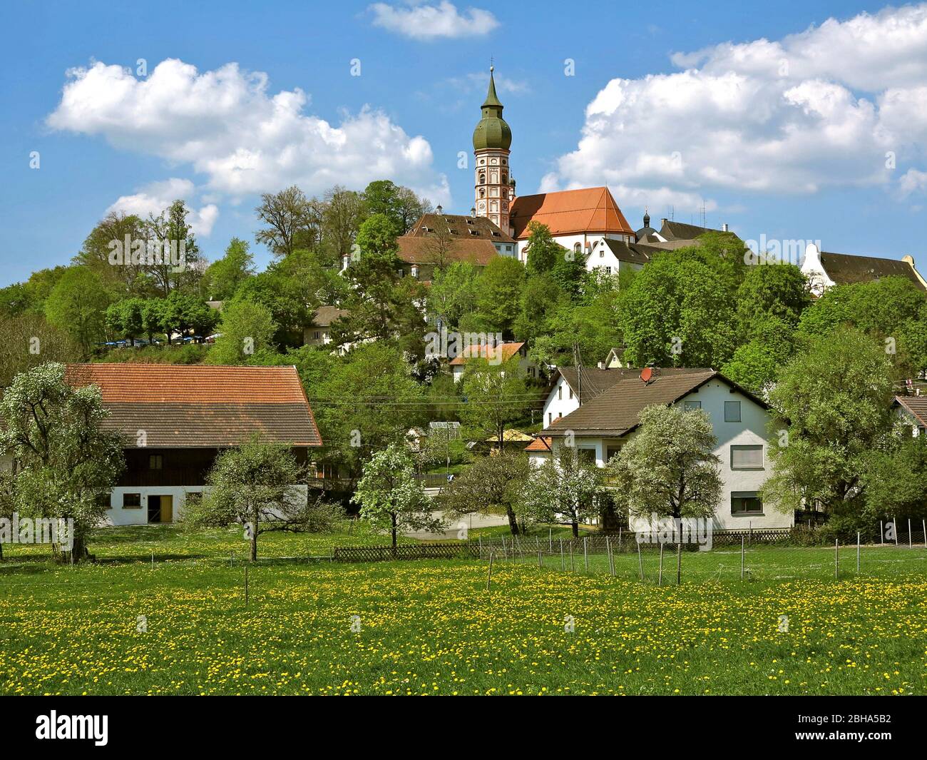 Germany, Upper Bavaria, Andechs, residential buildings and monastery church in spring Stock Photo