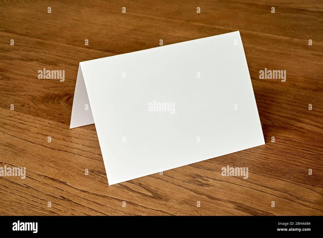 Standing Blank Empty Greeting Card Mock Up On Dark Wooden Background For Use As A Christmas Birthday Wedding Or Celebration Background Template Stock Photo Alamy