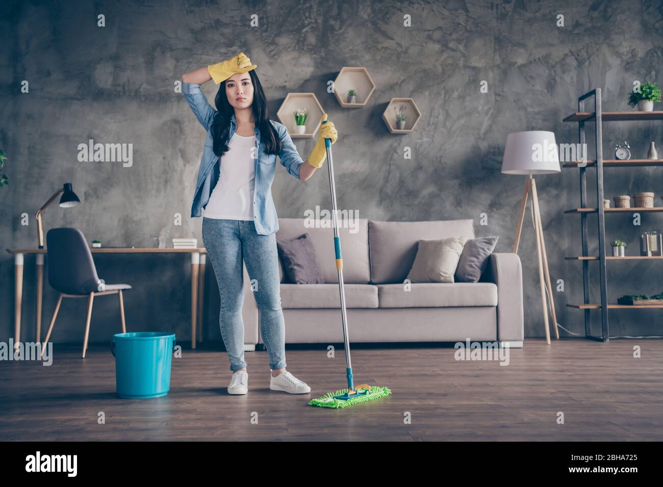 Full body photo of domestic tired asian lady standing living room