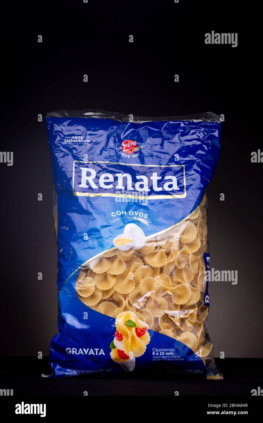 Bow tie pasta dough of the Brazilian brand Renata to prepare a macaroni dish. Studio low key product still life concept. Stock Photo