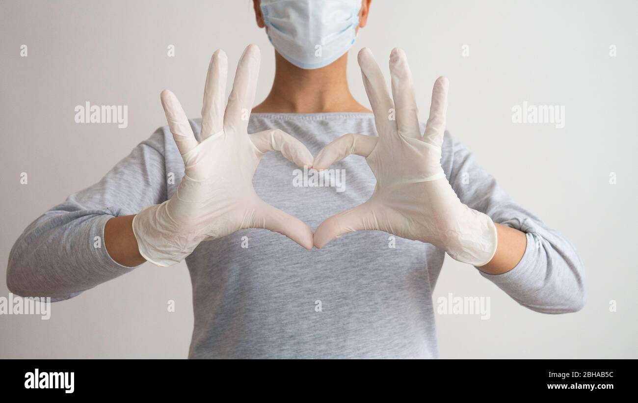 Female doctor or nurse with a medical mask and hands in latex white ...