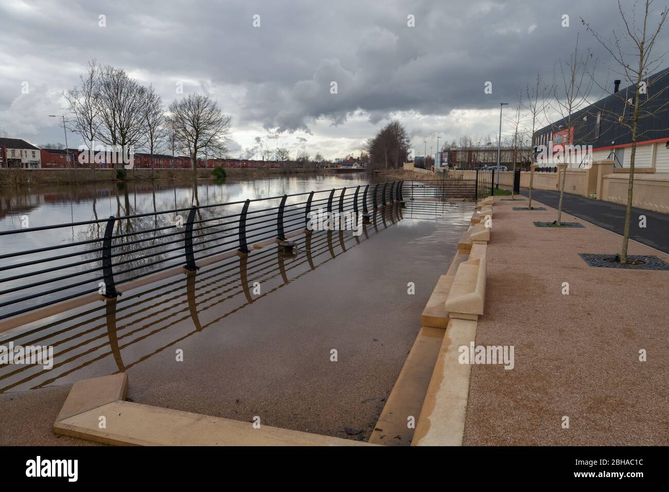 Viewing platform partly submerged at high tide along the waterside walkway beside the tidal flood defence scheme mear Warrington town centre. Stock Photo