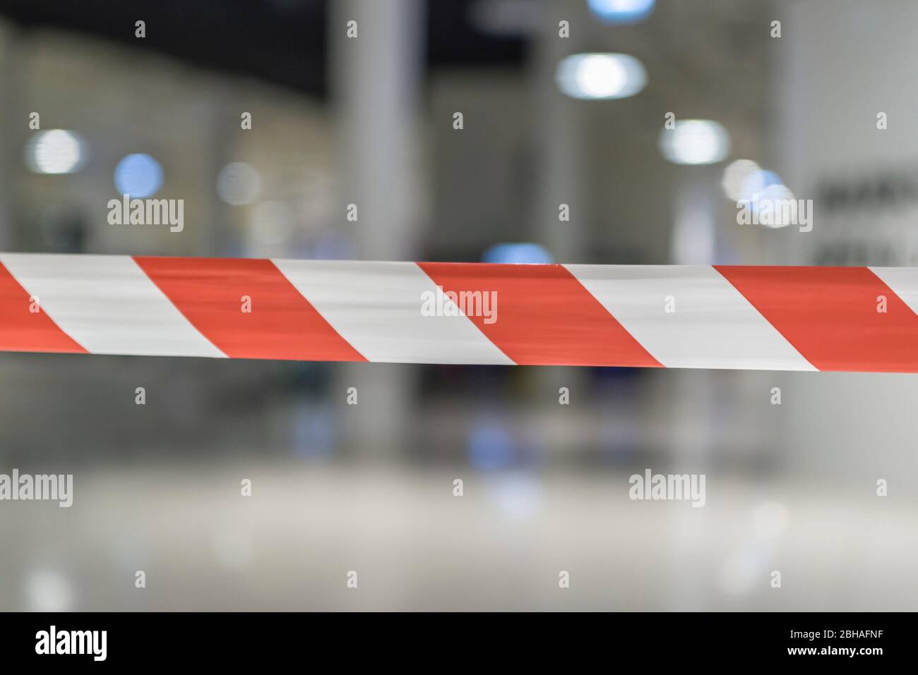 Red and white lines of the barrier tape. Red warning signal on a white background protects against penetration. Stock Photo