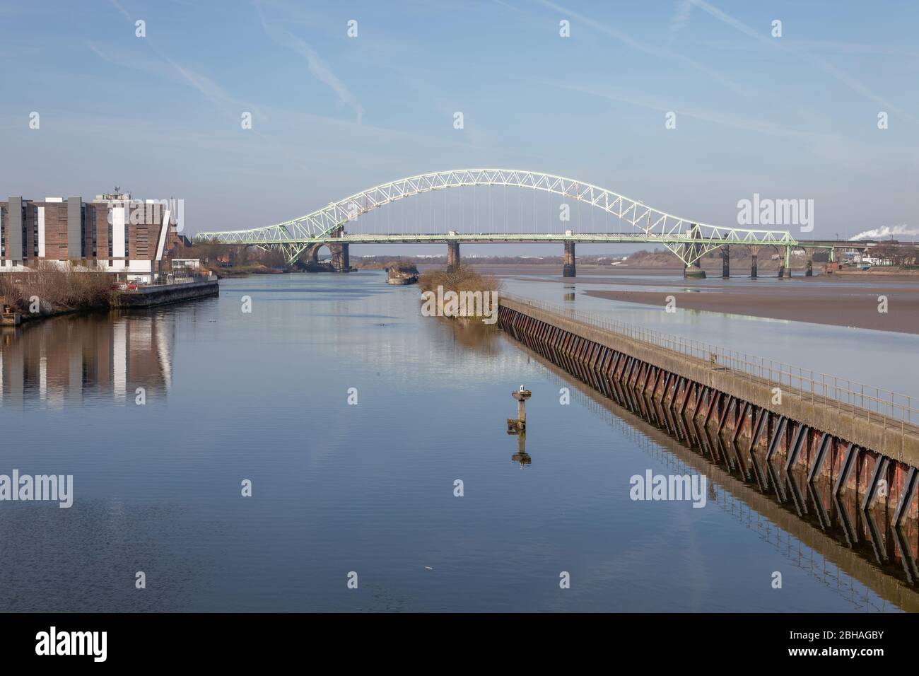 The Silver Jubilee Bridge between Runcorn amd Widnes and the Manchester Ship Canal seen from Wigg Island Community Park Stock Photo