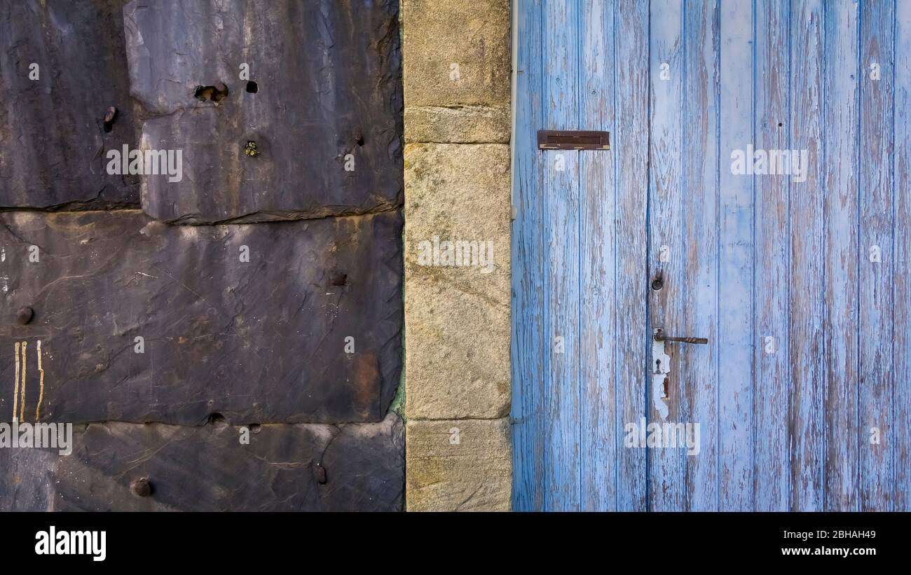 Wall cladding and old door in Le Pin near Vieussan. Located in the Regional Natural Park Haut-Languedoc. Stock Photo