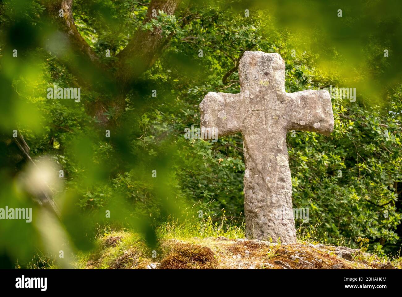 historic stone cross of stave church Fantoft surrounded by trees, Fantoftvegen Paradis, Hordaland, Norway, Scandinavia, Europe Stock Photo
