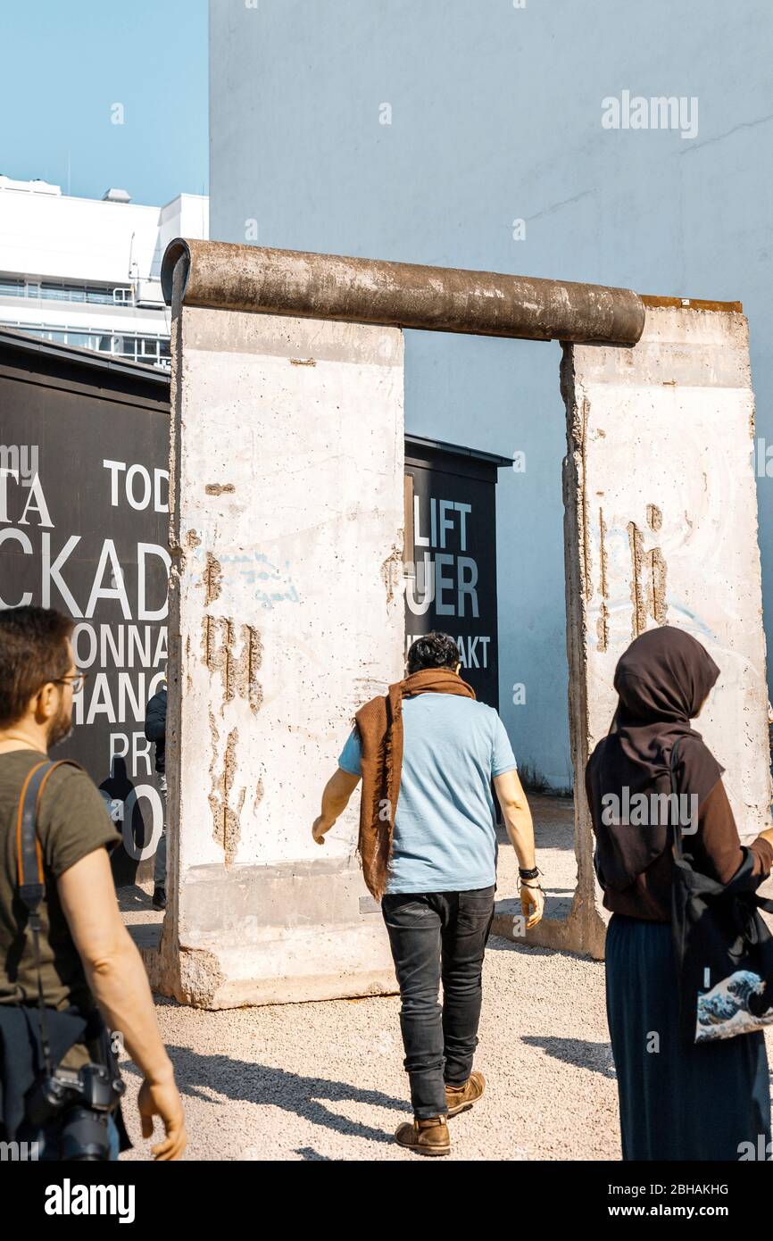 Touristen an der Berliner Mauer, historische Sehenswürdigkeit in der Hauptstadt. Nur redaktionelle Nutzung. Stock Photo