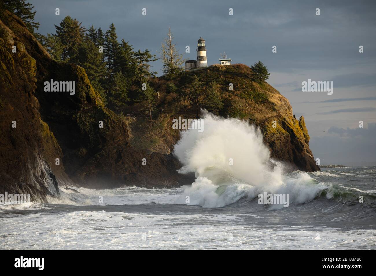 Crashing waves and lighthouse, Cape Disappointment State Park, Washington, USA Stock Photo