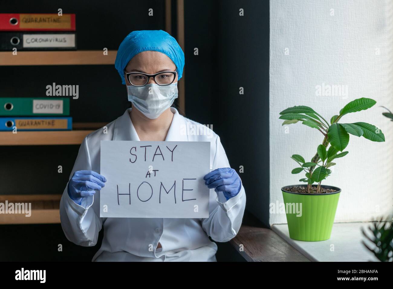 Stay At Home Sign From Female Doctor Stock Photo