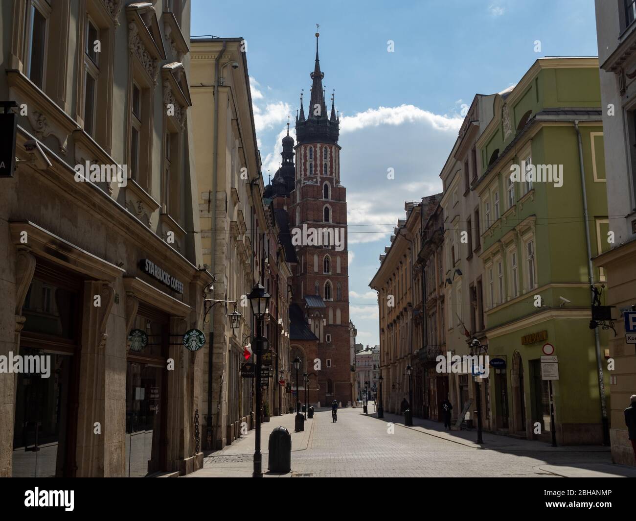 Cracow/Poland - 22/04/2020. Almost empty Florianska street in Krakow during coronavirus covid-19 pandemic.  At the end of the street towers of Mariack Stock Photo