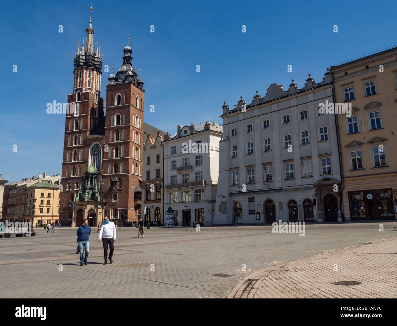 Cracow/Poland - 23/04/2020. Almost empty Main Square in Krakow during coronavirus covid-19 pandemic.  View over Mariacki Church. Stock Photo