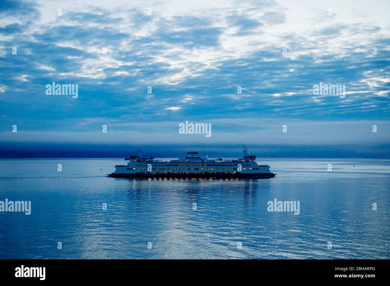 Ferry against cloudy sky at dusk, Seattle, Washington, USA Stock Photo