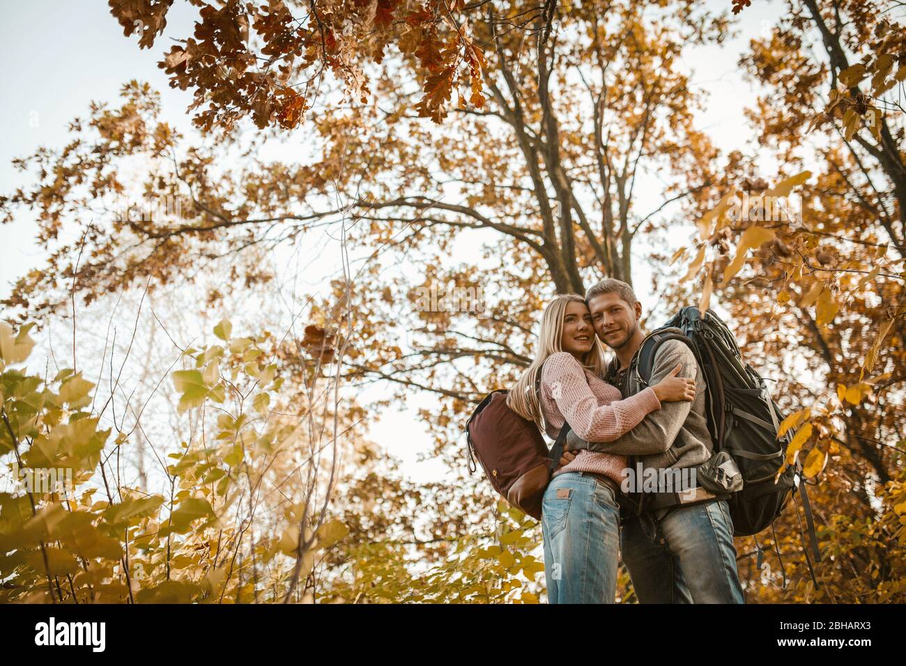 Man And Woman Hugs Standing In Autumn Forest Stock Photo