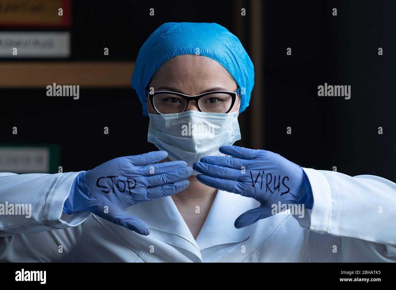 Doctor Saying STOP VIRUS Written On His Gloves. Stock Photo