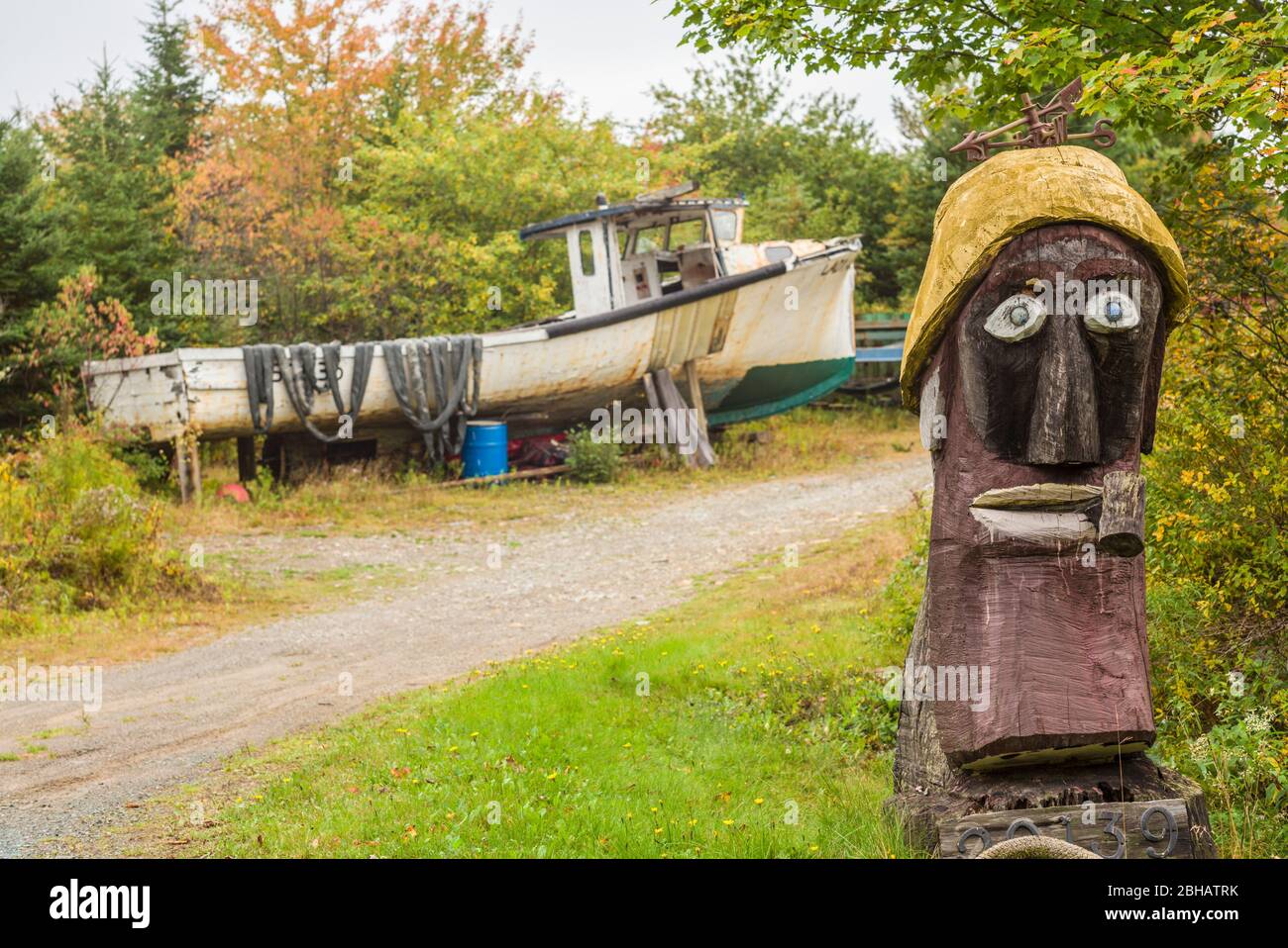 Canada, Nova Scotia, Marie Joseph, Folk Art figure and boat Stock Photo