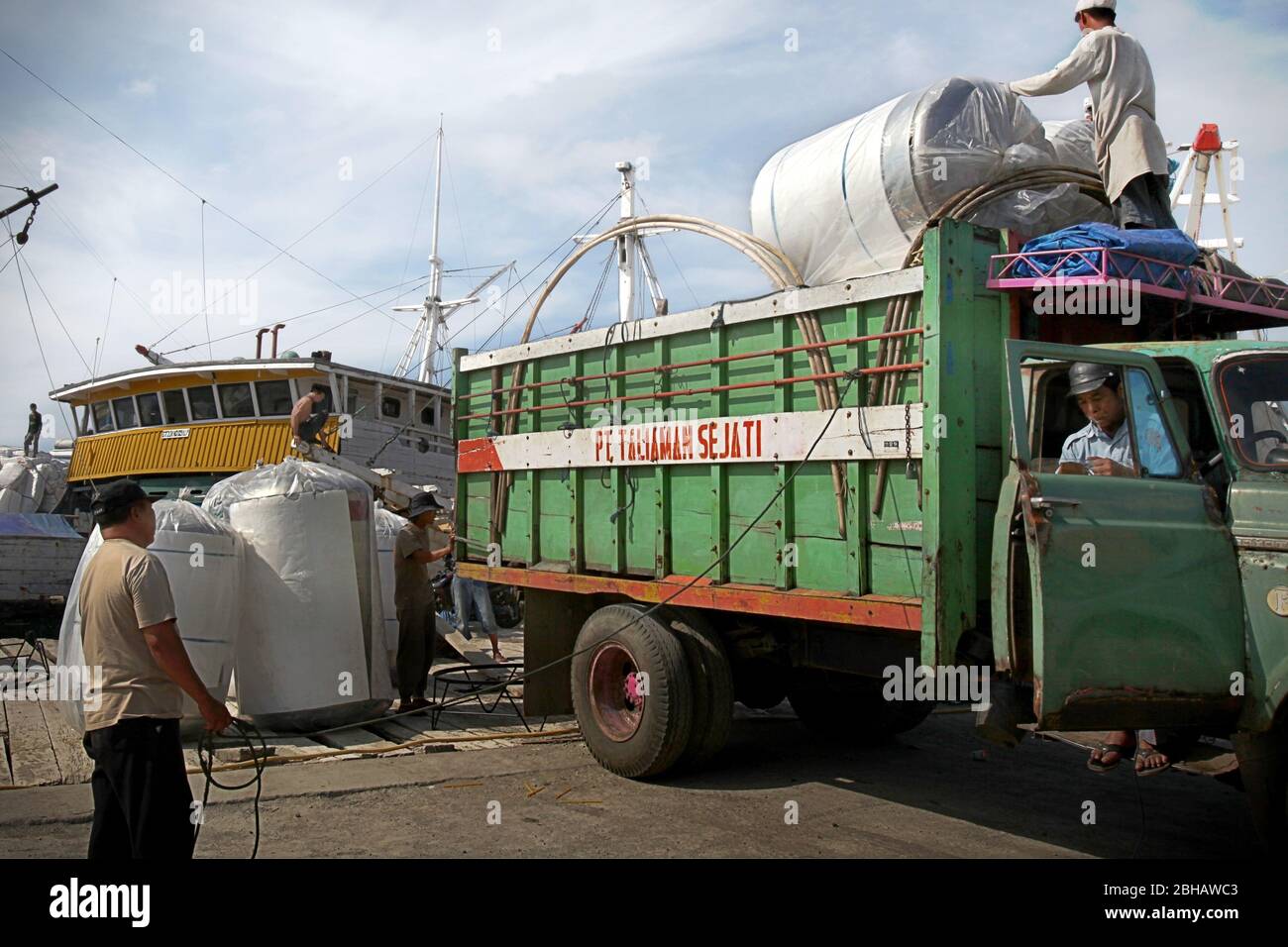 Workers unloading cargo for shipping at traditional port of Paotere in
