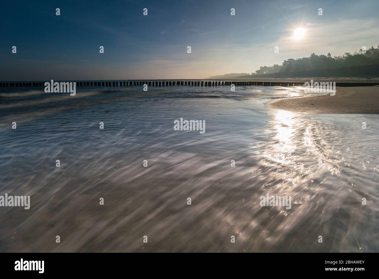 Sunrise in the winter by the sea with a falling mist of bright sun on a beautiful winter day Stock Photo