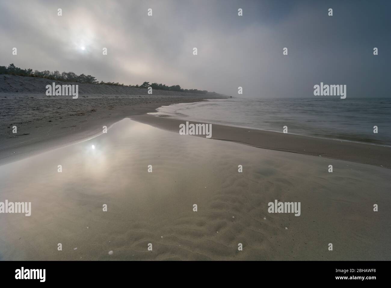Sunrise in the winter by the sea with a falling mist of bright sun on a beautiful winter day Stock Photo