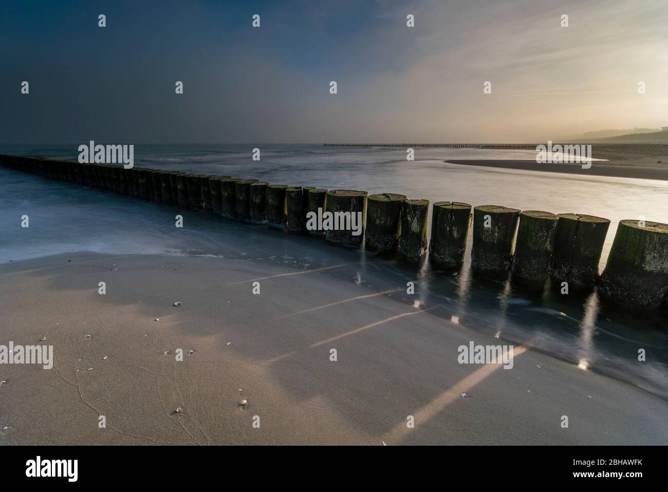 Sunrise in the winter by the sea with a falling mist of bright sun on a beautiful winter day Stock Photo
