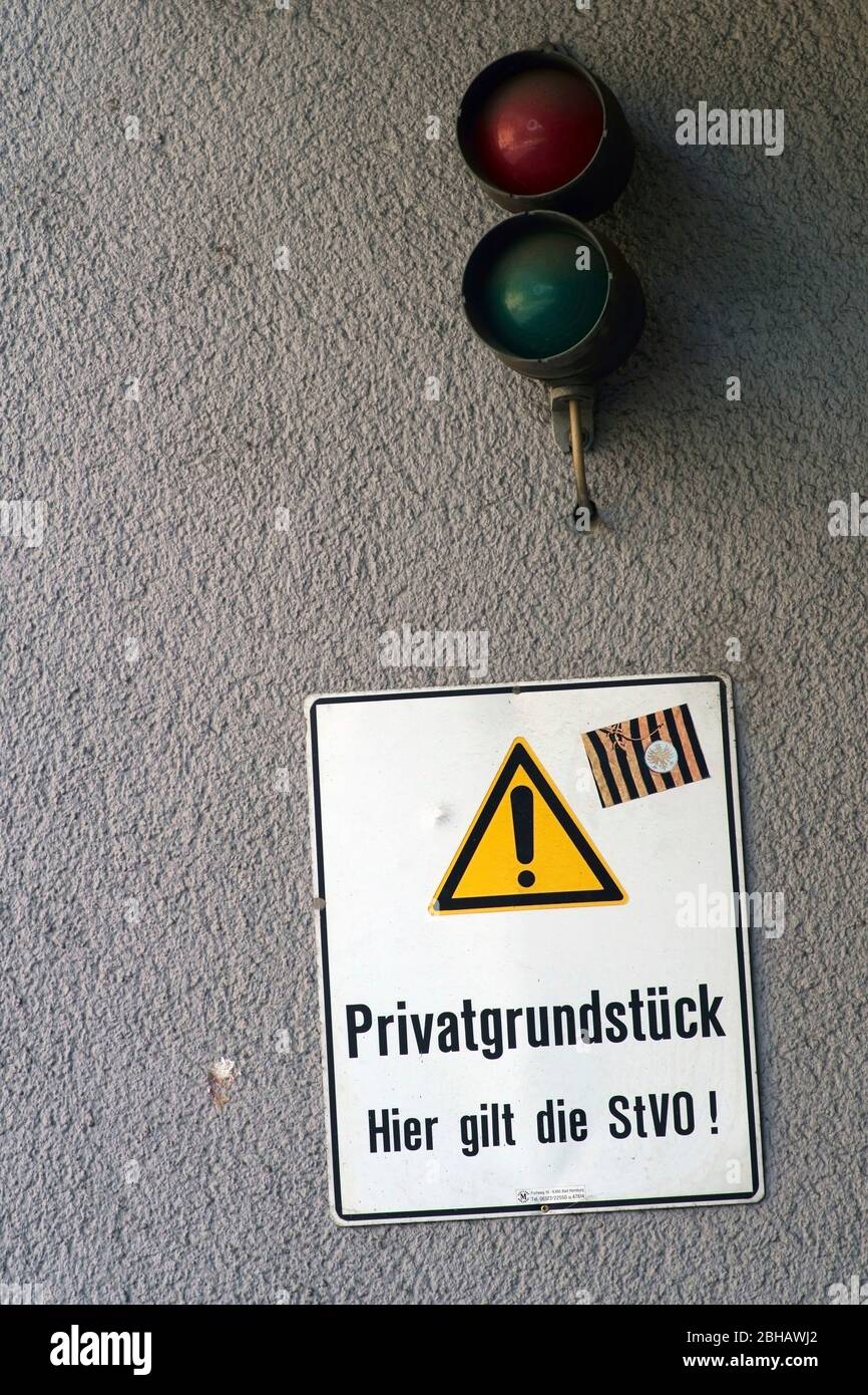 A traffic light and a sign hang at the gate of a garage Stock Photo Alamy