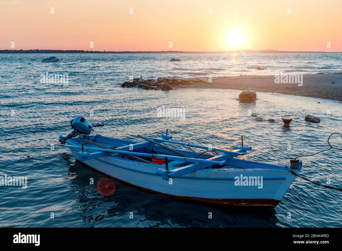 small boat moored on the beach of vrsi mulo at sunset, vrsi, zadar county, dalmatia, croatia Stock Photo