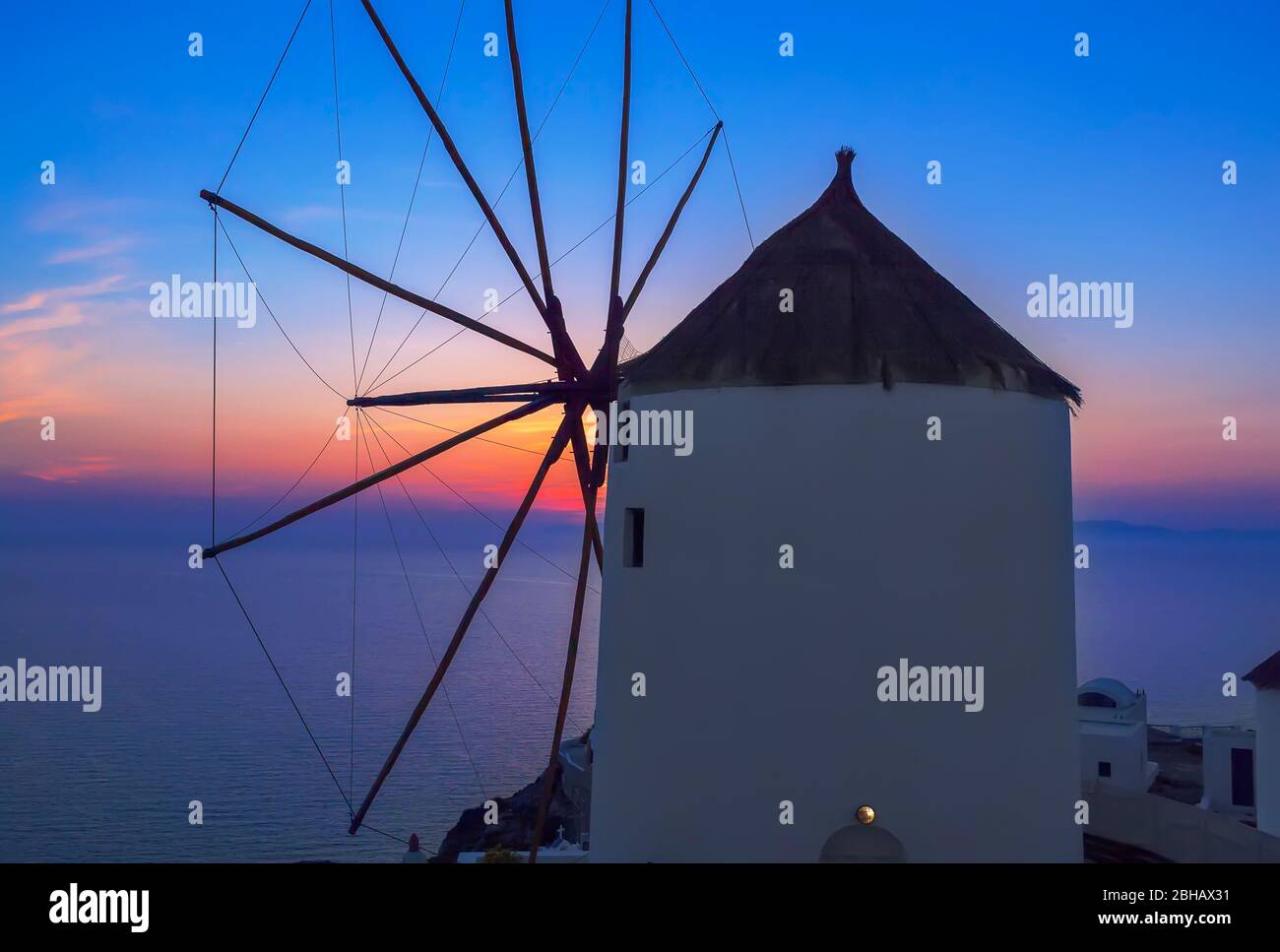 Windmill at sunset, Oia, Santorini, Cyclades Islands, Greece Stock Photo