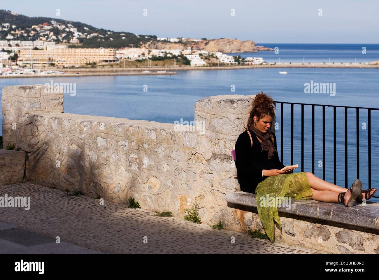 Woman reading in the Mirador El Revellí. Dalt Vila, Ibiza, Spain Stock Photo