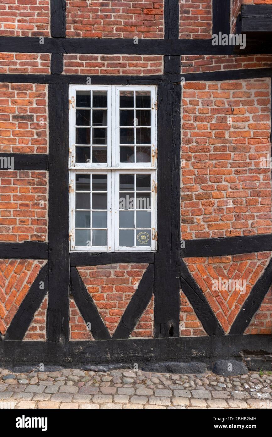 Denmark, Jutland, Ribe (oldest city of Denmark), brick facade with lattice window. Stock Photo