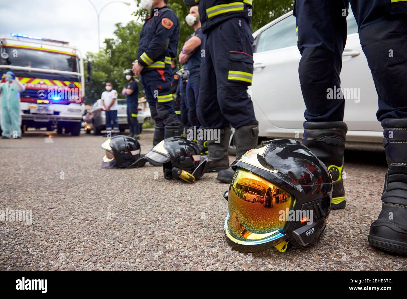 Firefighters in a moment of silence for the victims of the pandemic COVID19 during the applause.Since the start of the coronavirus outbreak and the state of alarm decreed by the Spanish government, people at 8pm as a tribute applaud the health personnel who return the applause from the different hospitals together with the police and members of civil protection. Stock Photo
