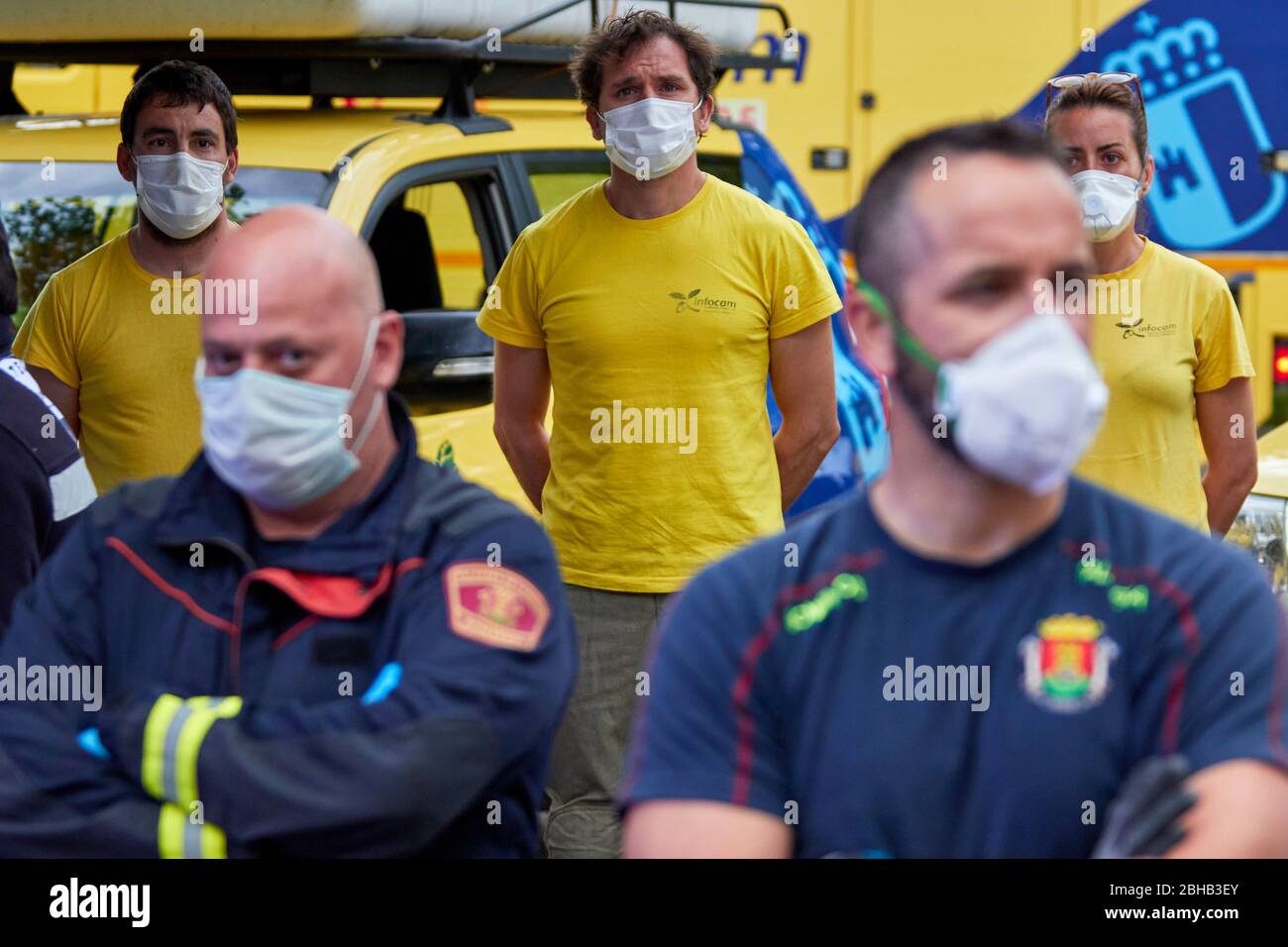 Firefighters wearing face masks in a moment of silence for the victims of the pandemic COVID19 during the applause.Since the start of the coronavirus outbreak and the state of alarm decreed by the Spanish government, people at 8pm as a tribute applaud the health personnel who return the applause from the different hospitals together with the police and members of civil protection. Stock Photo