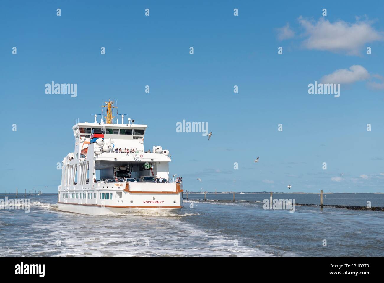 Germany, Lower Saxony, Ostfriesland, Norderney, the Norderneyfähre at the harbor exit of Norddeich. Stock Photo