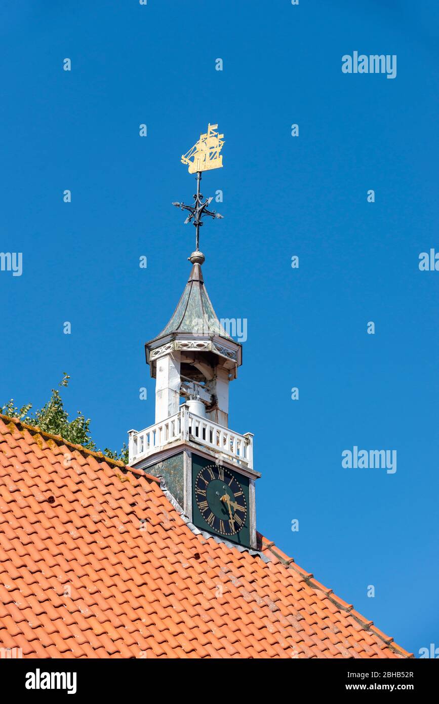 Germany, Lower Saxony, Ostfriesland, Greetsiel, roof ridge of the Protestant-Reformed Church, the 1730 weather vane in the form of a ship. Stock Photo