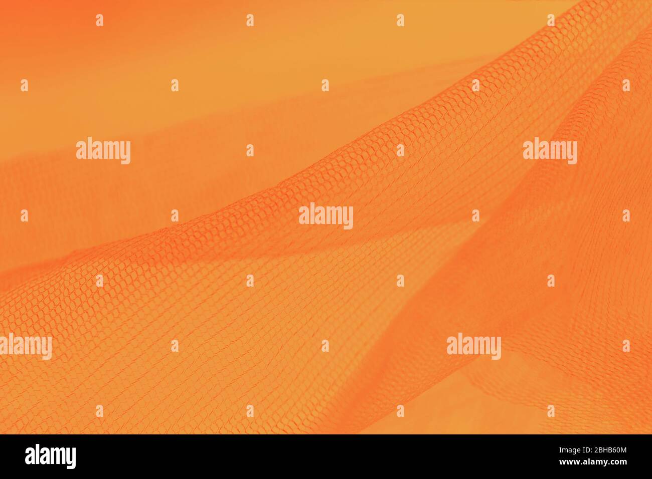 Small mesh fabric on orange background. Shades of orange color Stock ...