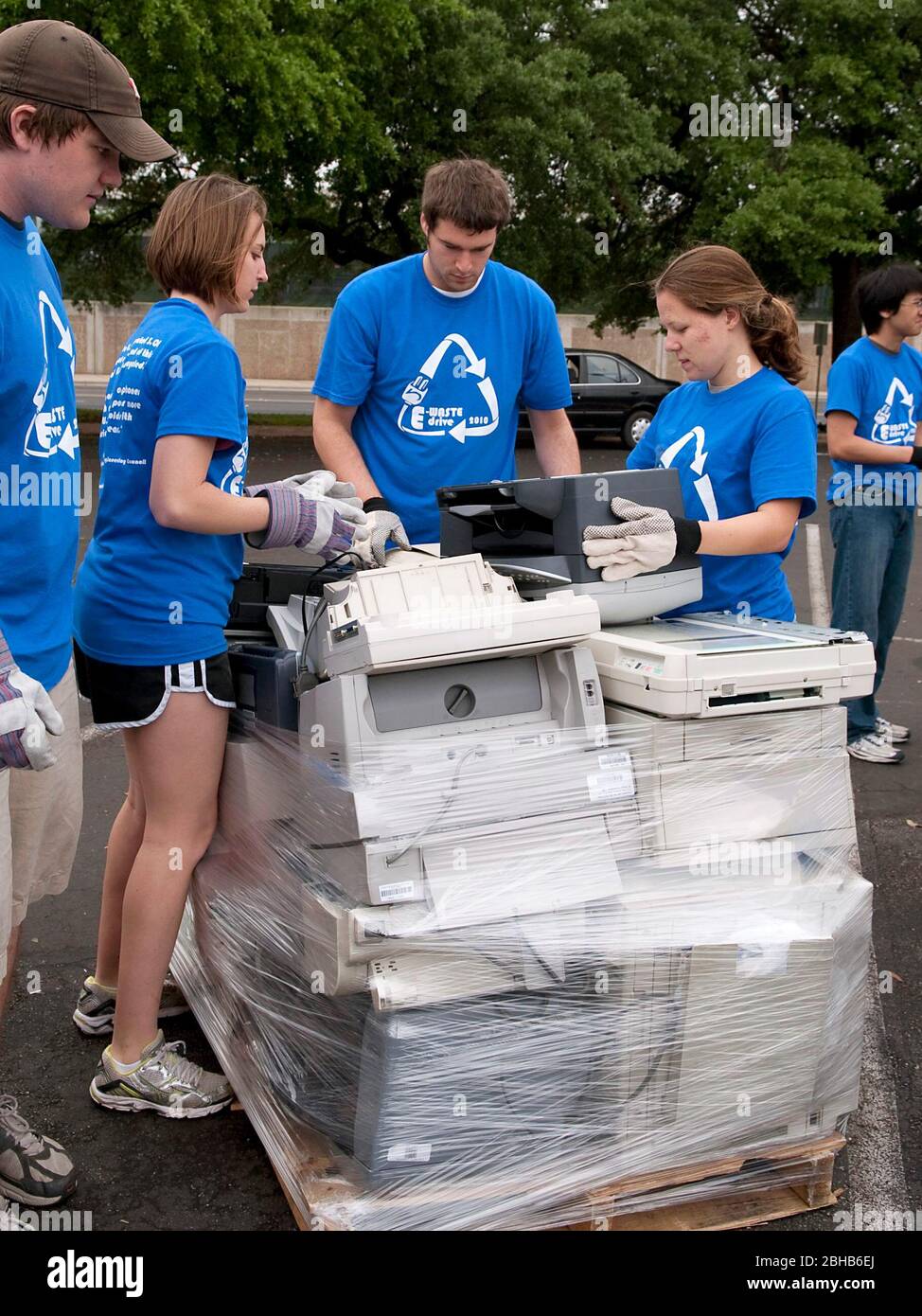 Austin Texas USA, April 17 2010: Engineering students from the University of Texas coordinate an 'E-Waste Drive' to recycle old computers and electronics from households and offices to keep  hazardous materials out of local landfills. About 50 stacks of computers, monitors, printers and televisions were hauled away for proper disposal in the day-long effort. ©Bob Daemmrich Stock Photo