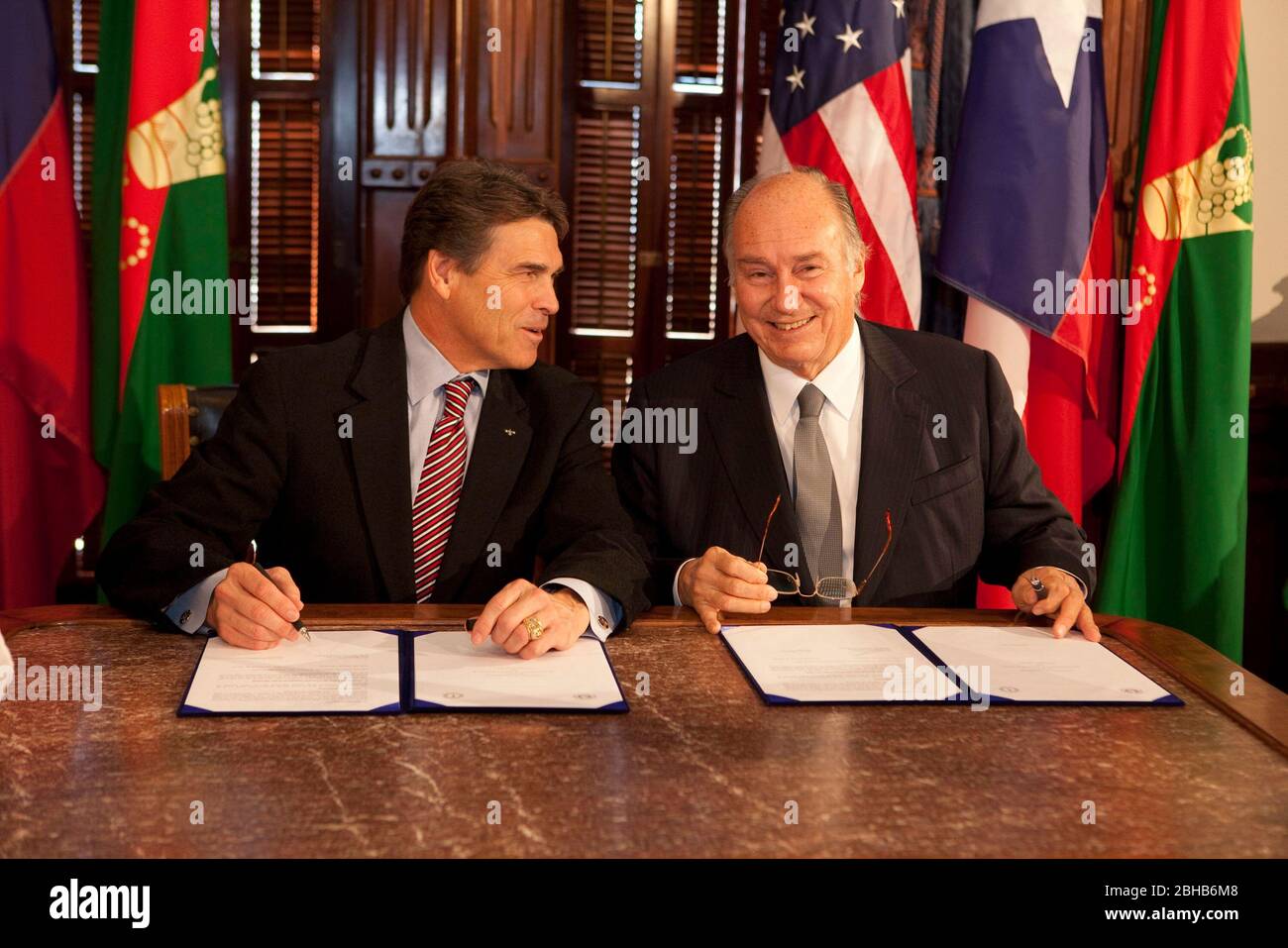 Austin Texas USA, October 30 2009: Texas Governor Rick Perry (l) and His Highness the Aga Khan (r) sign a Memorandum of Understanding (MOU) at the Texas Capitol emphasizing a willingness to work together on Middle Eastern charity projects proposed by His Highness. The Aga Khan is the spiritual head of 60 million Ismaili Muslims worldwide. ©Bob Daemmrich Stock Photo