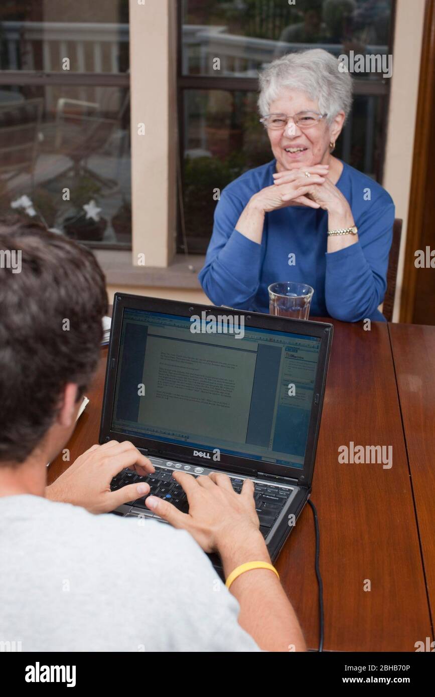 Austin Texas USA, May 8 2009: High school sophomore takes notes on a Dell laptop computer as he interviews his grandmother for an English class oral history project.  ©Bob Daemmrich Stock Photo