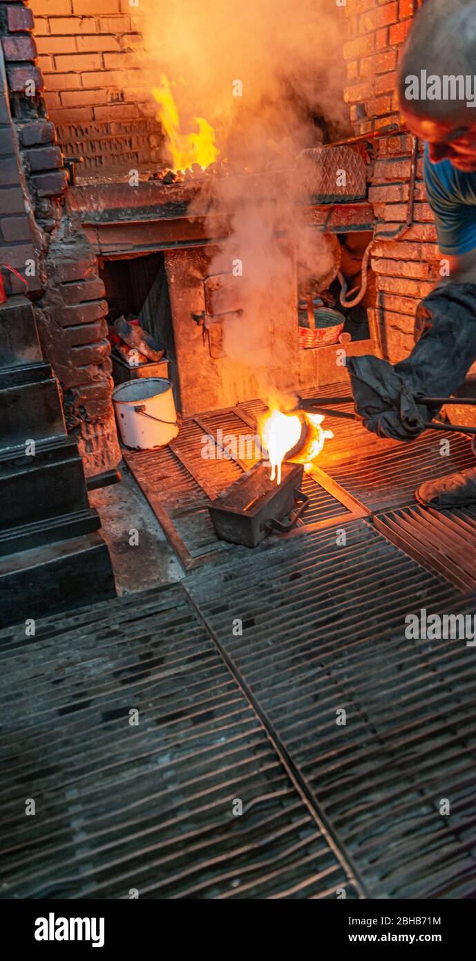 Craftsman melting gold in a foundry, creating gold bars / ingots in Istanbul, Turkey Stock Photo