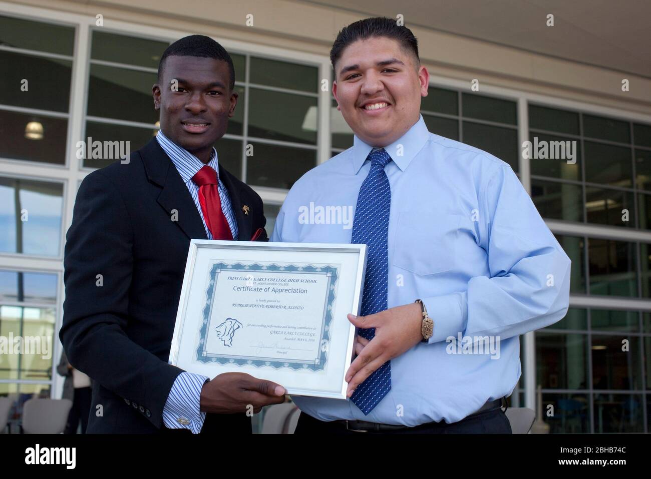 Dallas Texas USA, May 2009. High School students enrolled at the Garza Early College High School at Mountain View College show off a plaque at an awards presentation honoring the school for outstanding achievement.  ©Bob Daemmrich Stock Photo