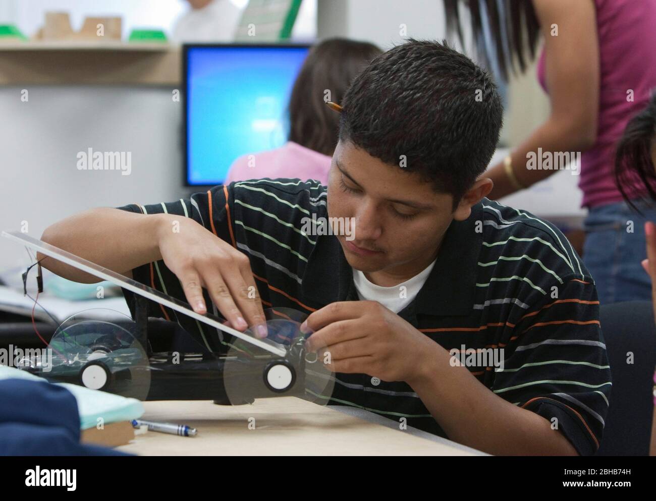 Manor Texas USA, May 12 2022: Student works to construct model solar car as part of class project at Manor New Tech High School, an innovative public school that centers on project-based learning in TSTEM (Technology Science Engineering Mathematics) curriculum.  ©Bob Daemmrich Stock Photo