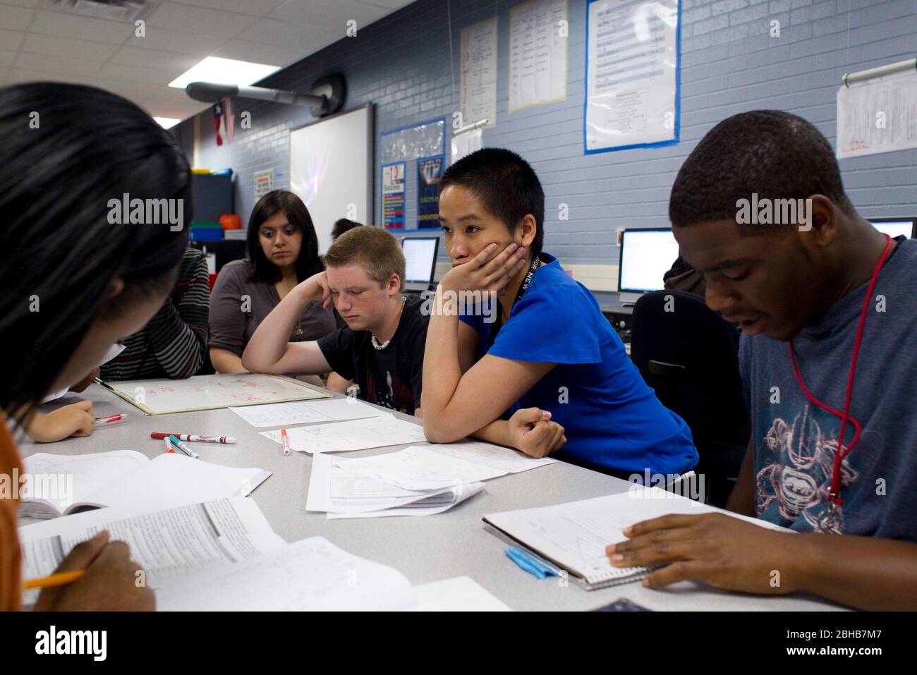 Manor, Texas USA, May 11, 2010 Female mathematics teacher (in blue) works with high school