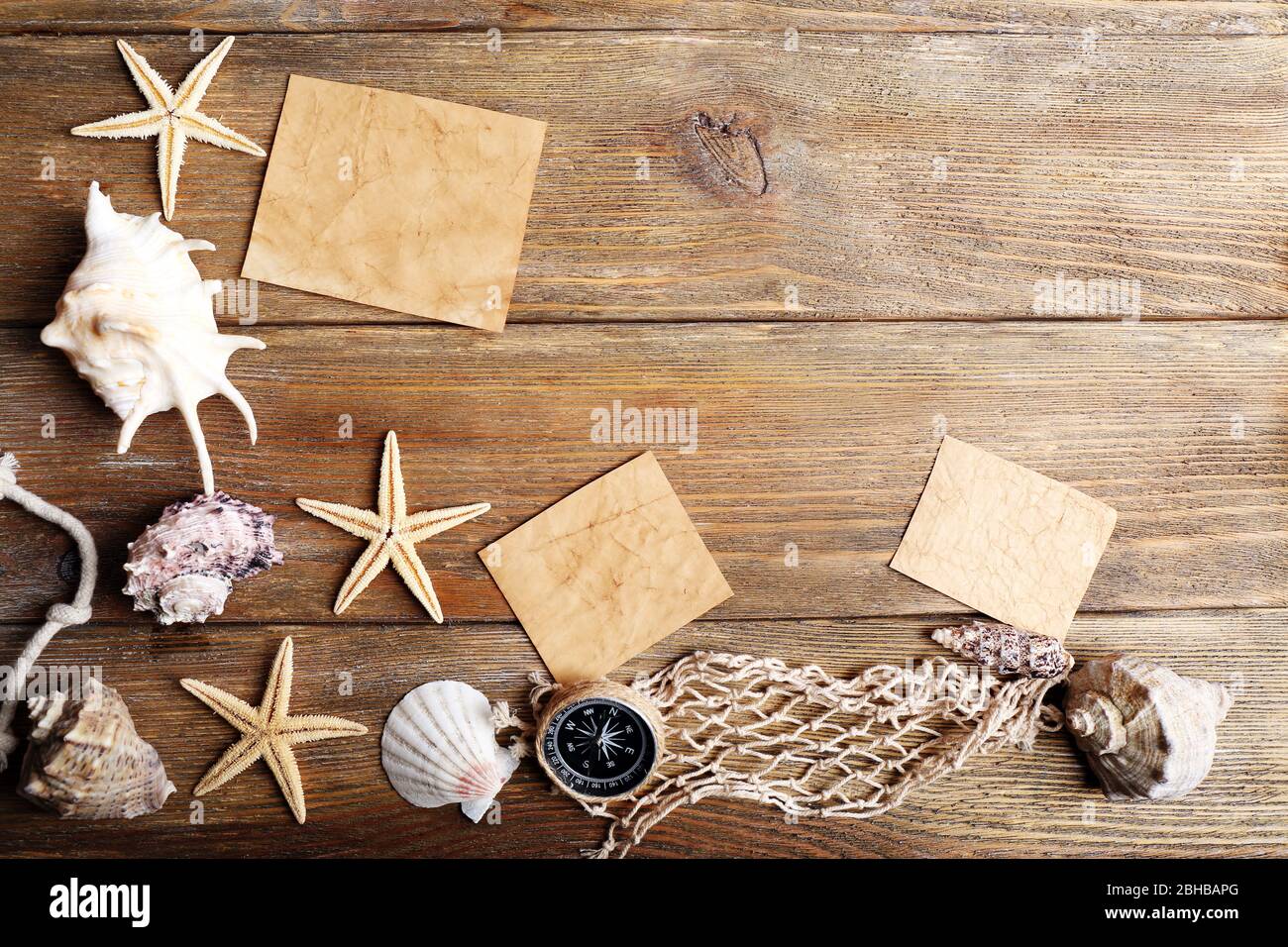 Card blanks with sea stars and shells on wooden background Stock Photo