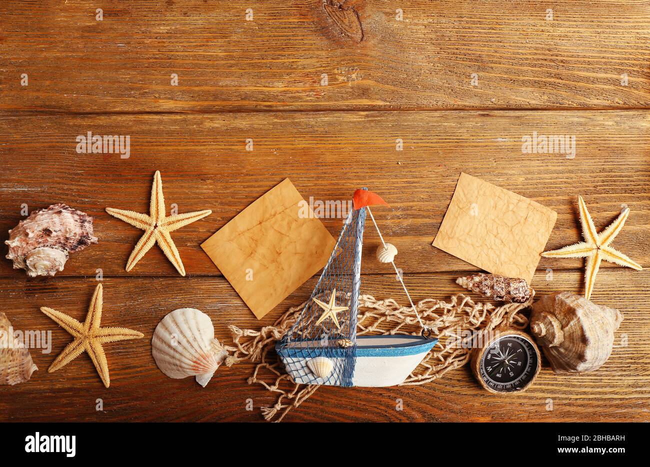 Beautiful sea composition with boat and shells on wooden background Stock Photo