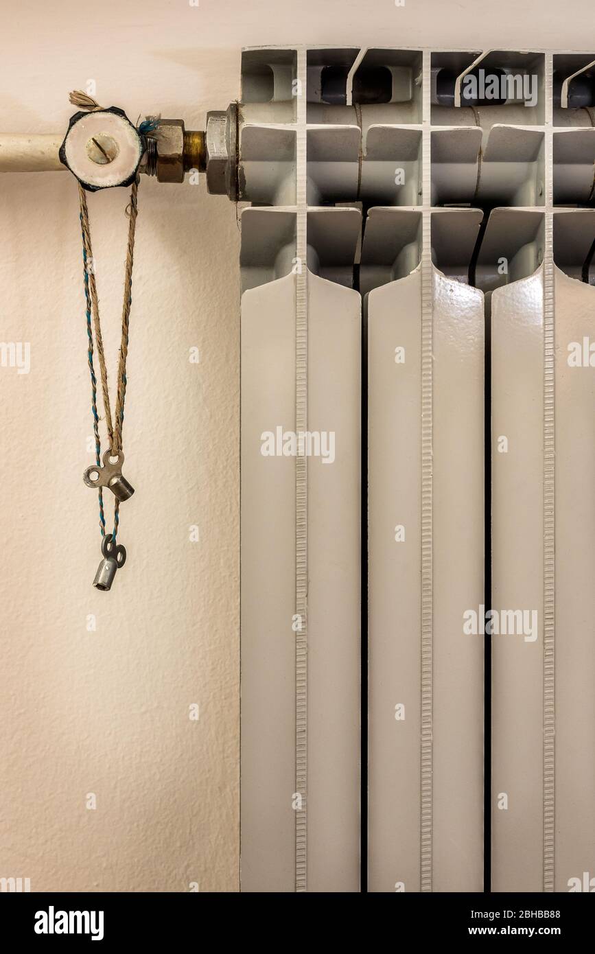 Close up heating radiator with Radiator Keys Brass Air Vent Clock Type