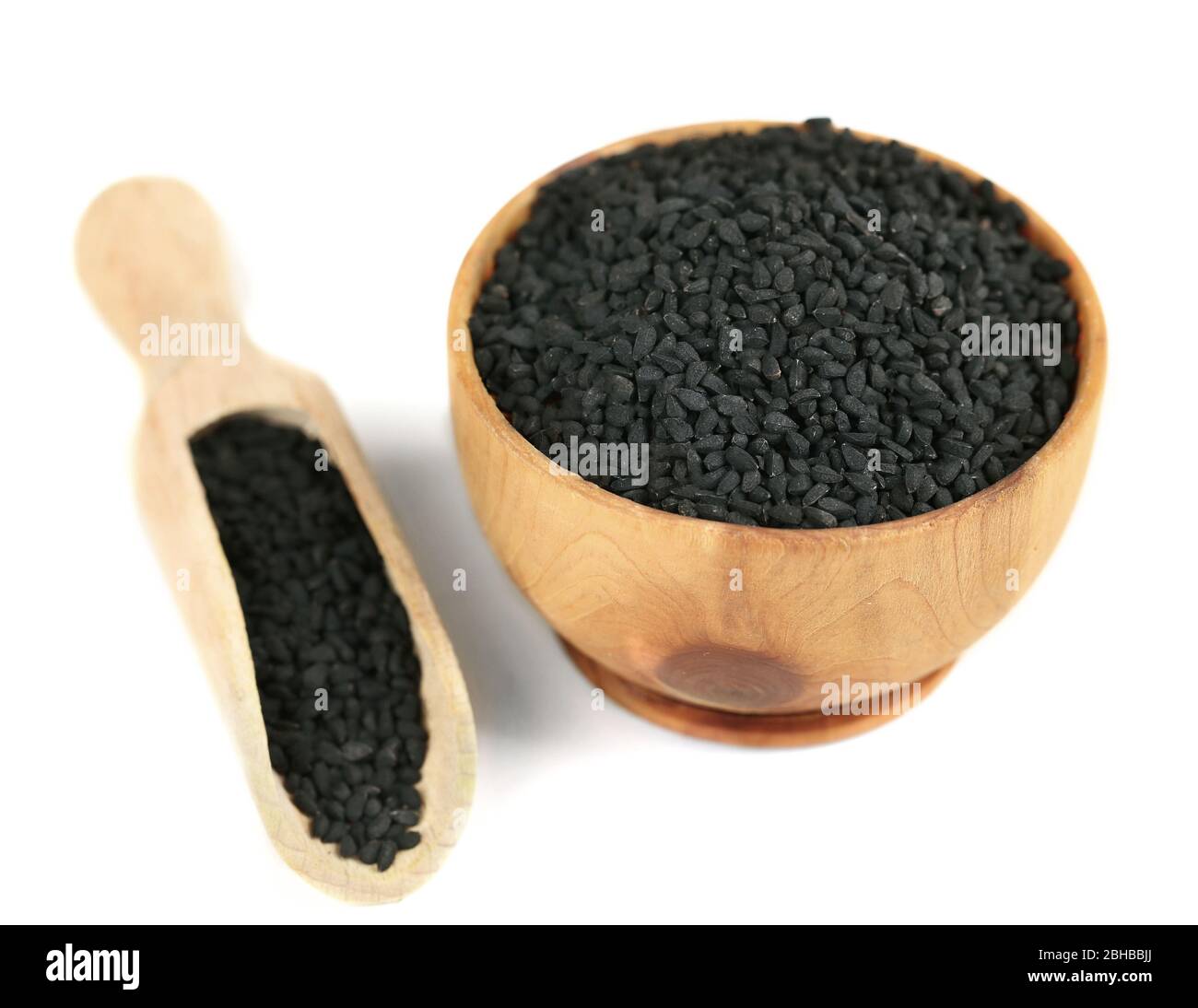 Black sesame in wooden bowl, isolated on white Stock Photo - Alamy
