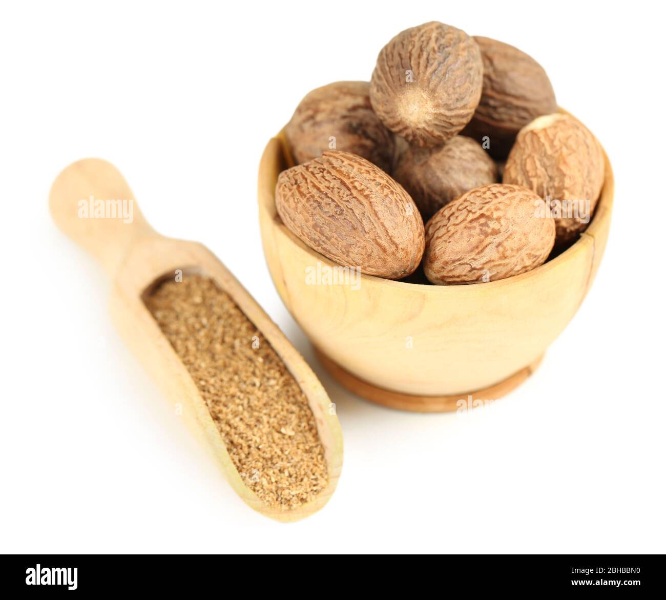 Nutmeg in wooden bowl, isolated on white Stock Photo Alamy