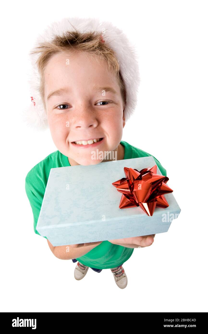 A small boy with a Christmas present looking up, high view looking down on child. Stock Photo