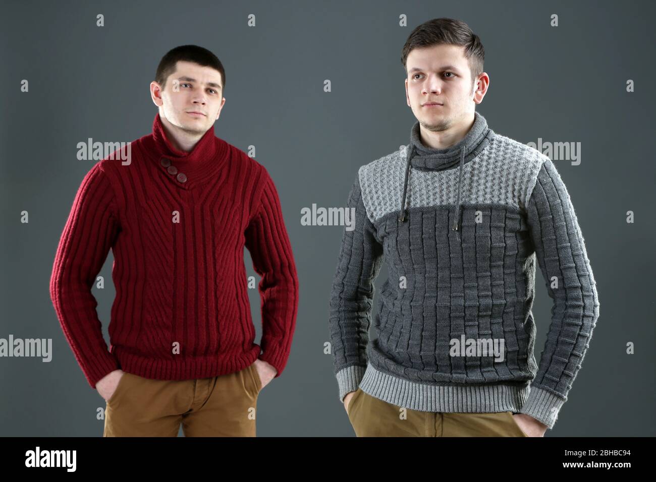Two handsome young men on gray background Stock Photo - Alamy
