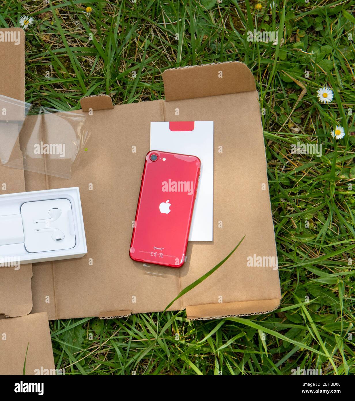 Paris, France - Apr 24, 2020: Parcel with new budget Red iPhone SE by Apple Computers touch ID, Single-lens rear camera and iPhone 8 design with internals from 11 Pro version Stock Photo