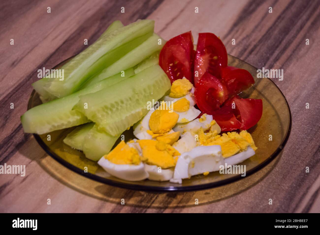 Glass plate with healthy food, full with tomatoes cucumbers and eggs
