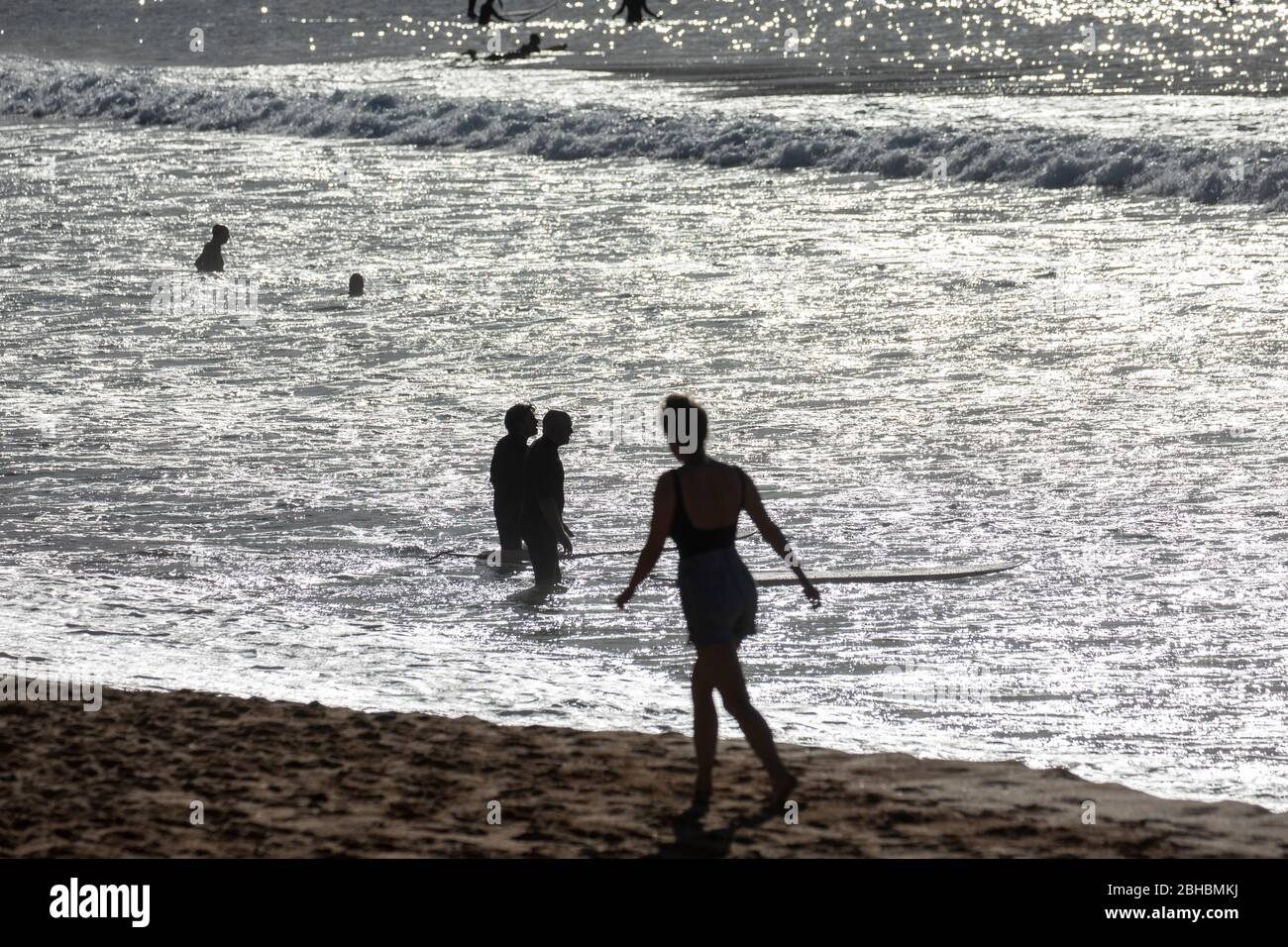 Early morning Sydney beach people exercise and surf on the beach early in the day,Australia Stock Photo